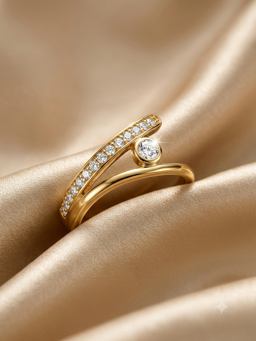 A gold ring with a curved pavé-set diamond band and a round diamond accent, displayed on draped champagne satin fabric.