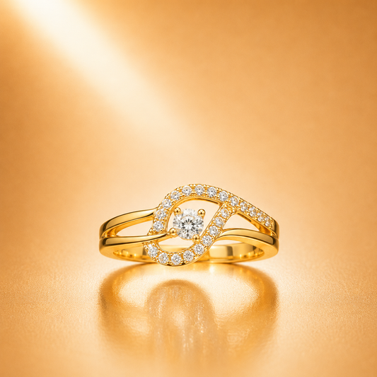 A gold ring with a central round diamond and an openwork halo of small diamonds, displayed on a warm gold reflective surface.