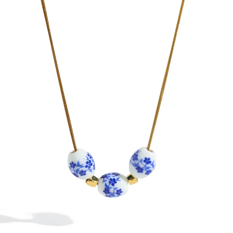 Necklace with blue floral beads on a white background