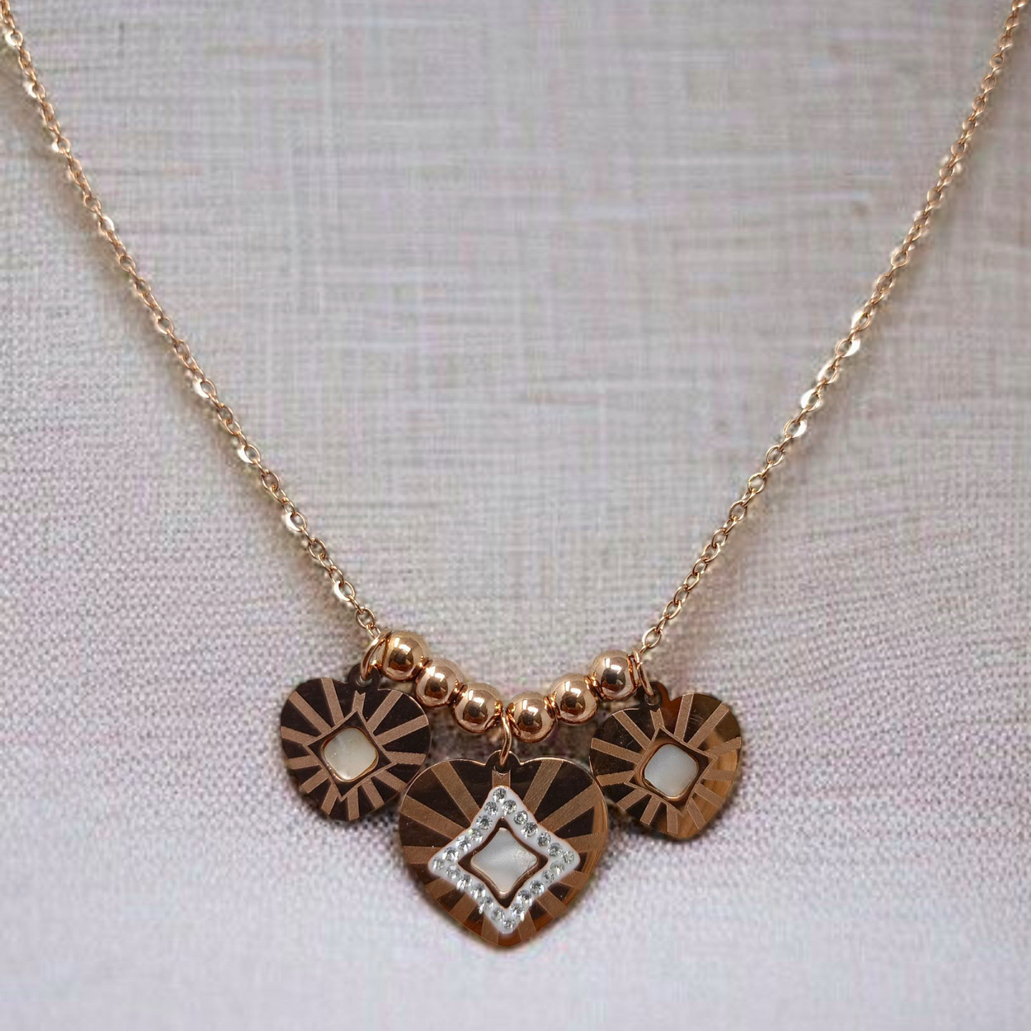Necklace with heart-shaped pendants on a light background