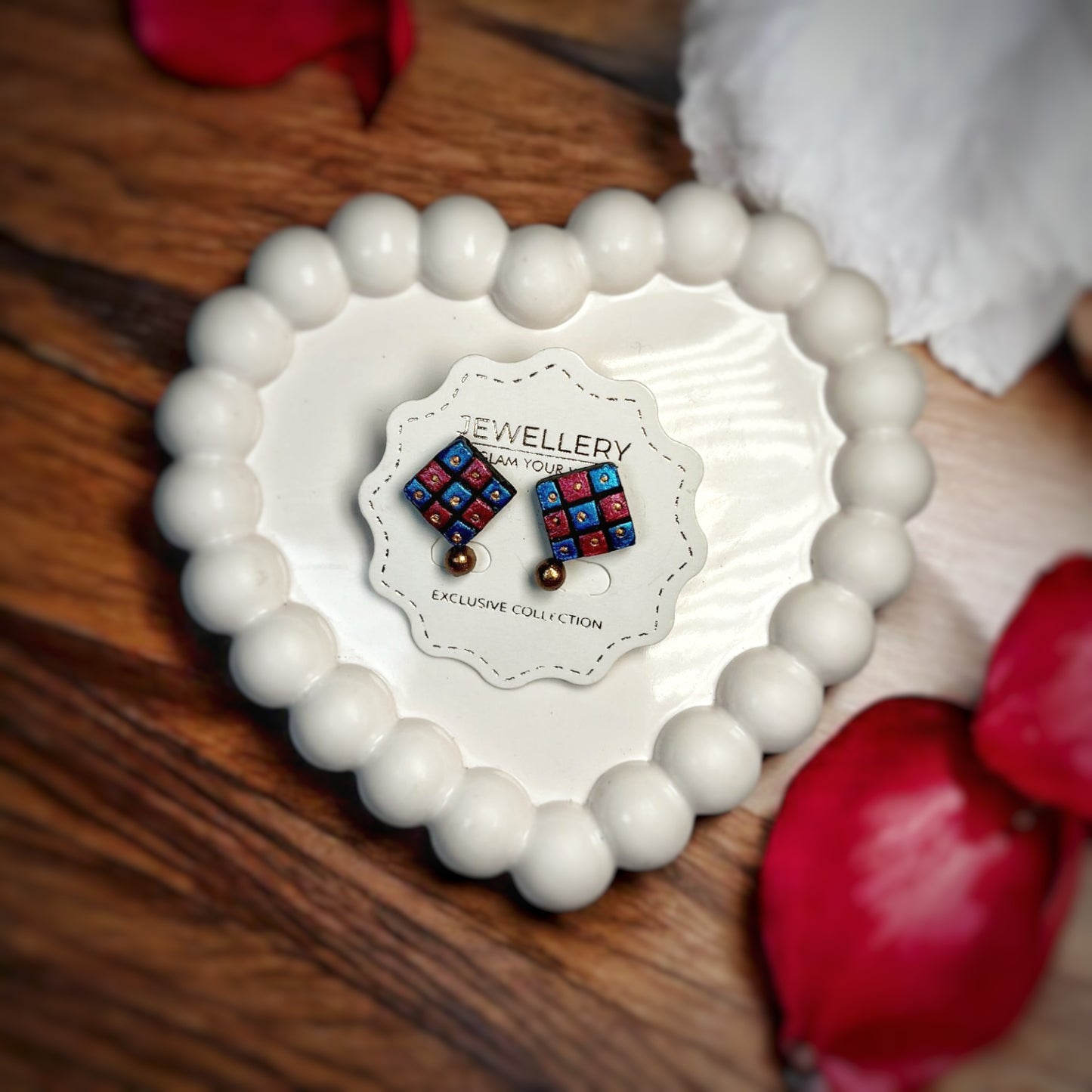 Terracotta Square Stud Earrings Handmade Jewelry in red and blue displayed on a white ceramic heart-shaped dish
