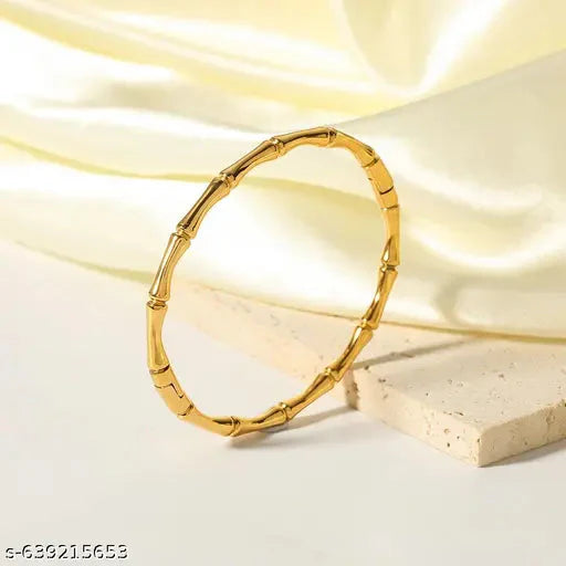 Handcrafted home decor featuring elegant gold and silver bracelets designed for stylish layering on a blue backdrop