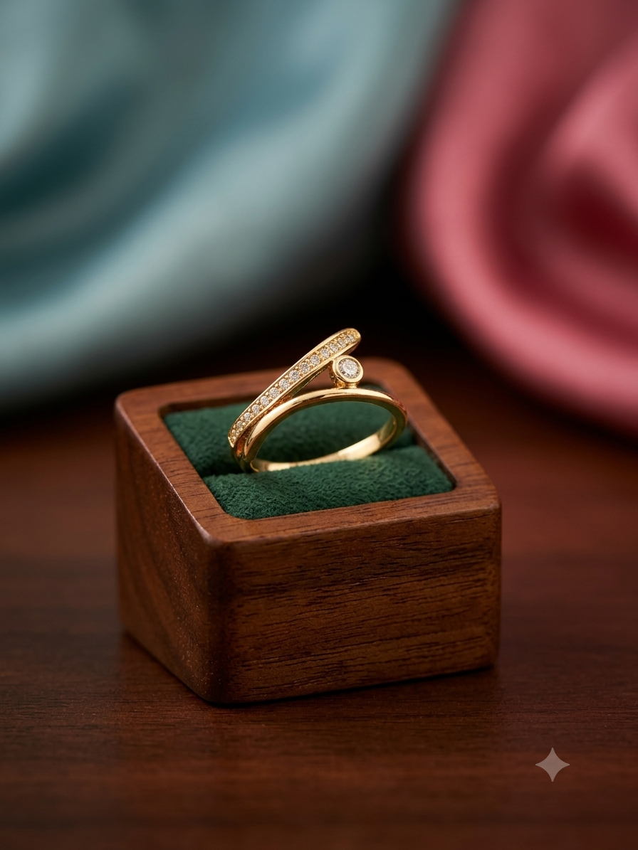 A gold ring with a pavé-set round diamond and a small center stone, displayed on a dark green velvet-lined wooden ring box on a wooden table.