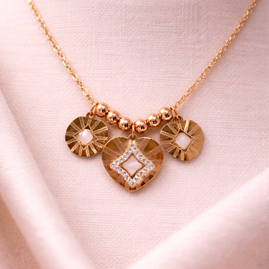 Rose gold necklace with heart-shaped pendant on a white mannequin bust