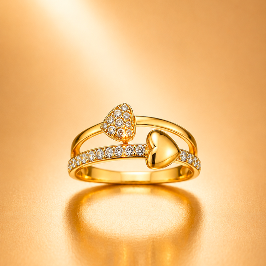 A gold ring set featuring three heart motifs: one pavé-set heart, one smooth polished heart, and one channel-set heart, all on a warm gold background.