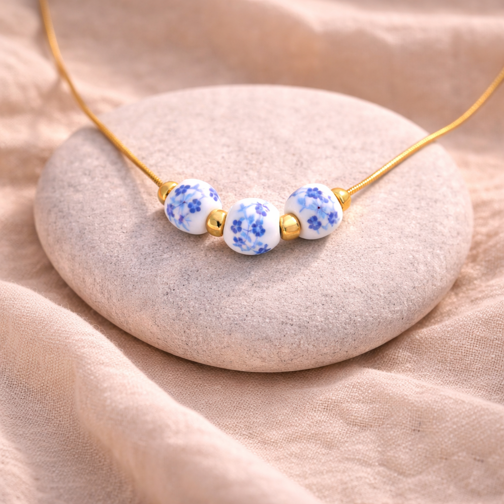 Necklace with blue floral beads on a beige stone