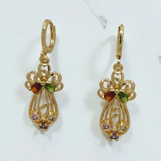 Gold earrings with gemstones on a white background