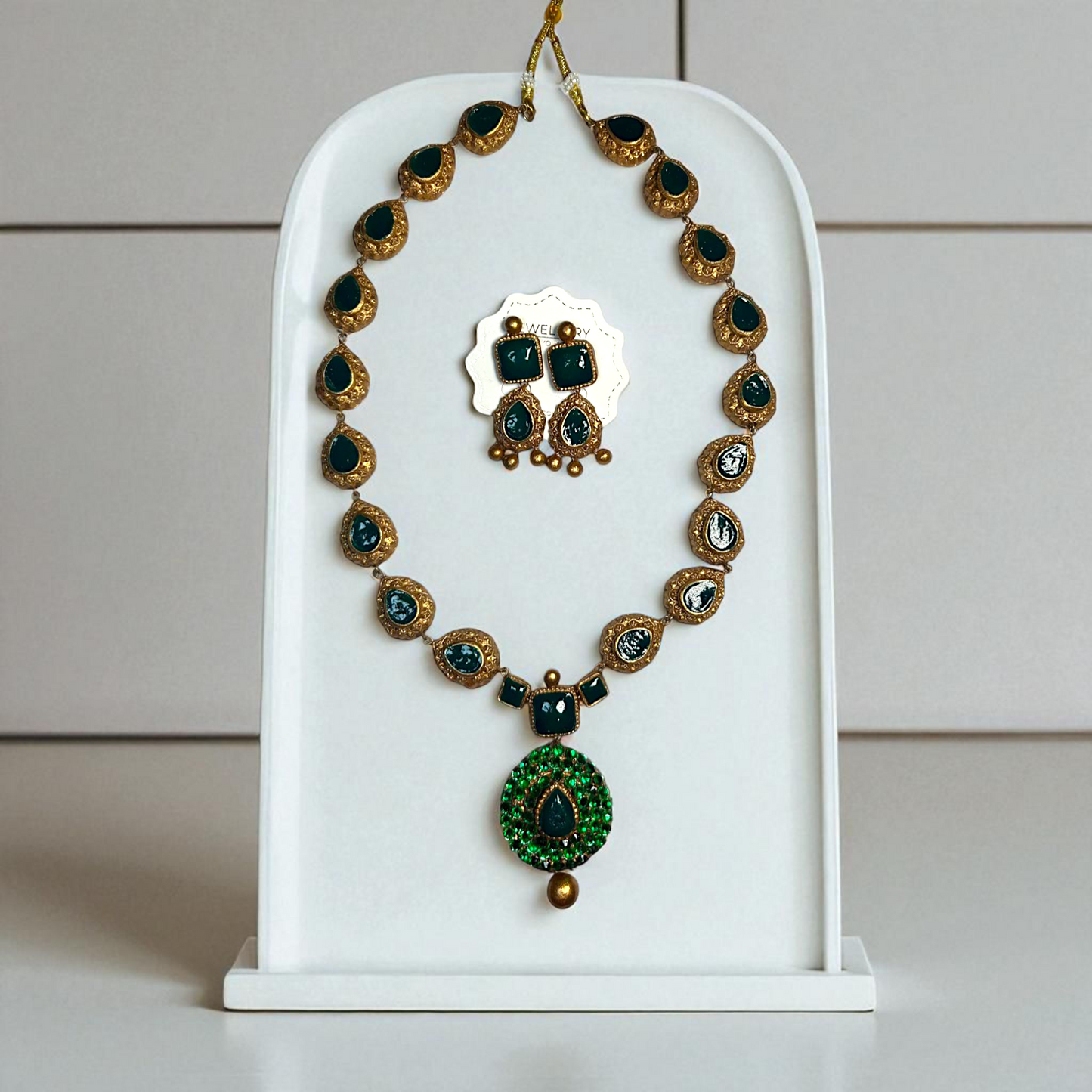 Terracotta Jewelry Ethnic Green Gemstone Necklace and Earring set displayed on white stand by ASTRIA JEWELLERY